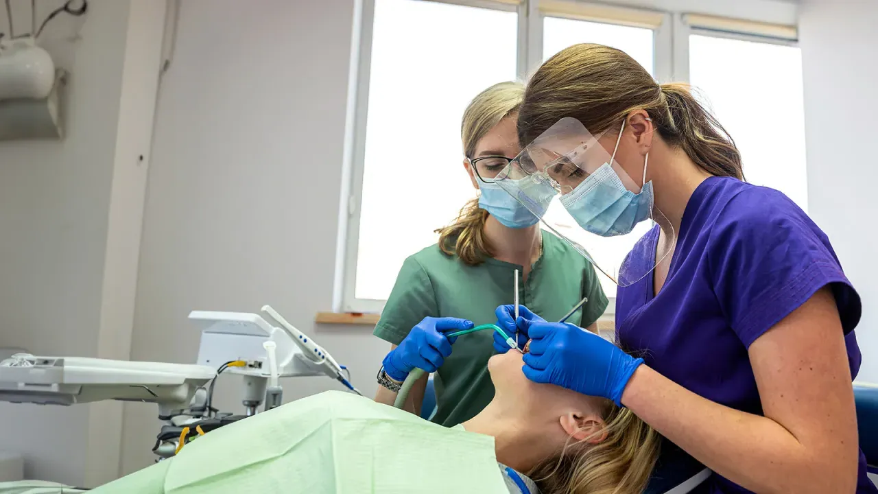 Dental students cleanint teeth